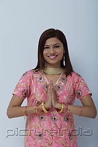 PictureIndia - Young woman dressed in traditional Indian clothing (salwar kameez)