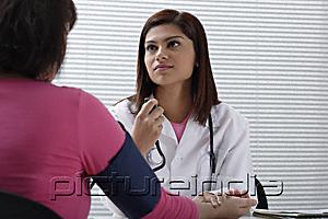 PictureIndia - Doctor taking pulse of patient
