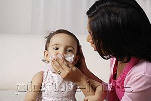 PictureIndia - woman wiping her baby's mouth after meal