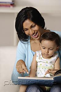 PictureIndia - woman flipping picture book with baby