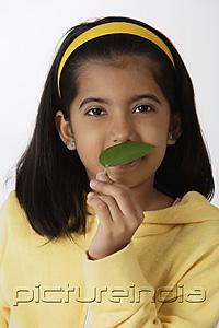 PictureIndia - Girl smelling green leaf