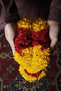 PictureIndia - Hands holding flower garlands.