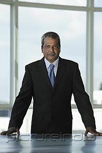 PictureIndia - Indian business man standing at desk