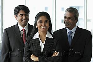 PictureIndia - Two business men looking at their female colleague