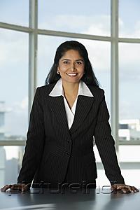 PictureIndia - Indian woman standing at her desk