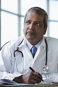 PictureIndia - Portrait of Indian doctor thinking and writing