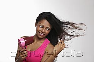 PictureIndia - woman blow drying her long hair
