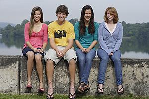 Mind Body Soul - Group of teens sitting on wall next to lake