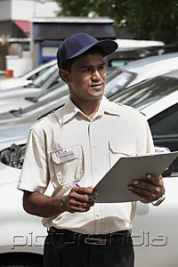PictureIndia - Security guard writing on clipboard