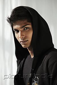 PictureIndia - Head shot of young man wearing a hood