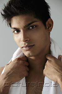 PictureIndia - head shot of  young man with towel around his neck