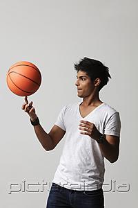 PictureIndia - young man twirling basket ball on his finger