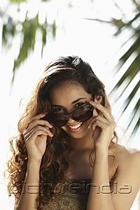 PictureIndia - young woman looking out from sunglasses