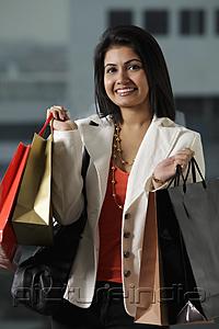 PictureIndia - woman holding shopping bags and smiling