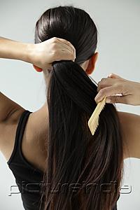 PictureIndia - back shot of woman combing her long hair