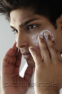 PictureIndia - head shot of young man washing face