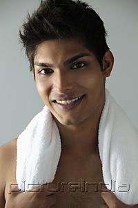 PictureIndia - head shot of young man with towel around his neck and smiling
