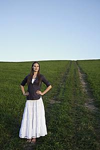 Mind Body Soul - Young woman standing in grassy meadow