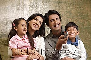 Asia Images Group - father holds phone up in family portrait