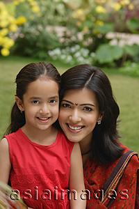 Asia Images Group - mother and daughter in garden, close up, smiling at camera