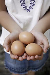 Mind Body Soul - girl holding brown eggs
