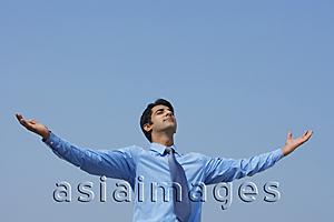 Asia Images Group - businessman with arms outstretched, eyes closed