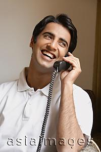 Asia Images Group - man laughs while talking on phone
