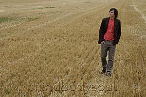 Mind Body Soul - Young man standing in a field