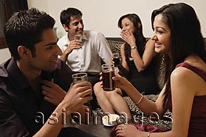 Asia Images Group - two couples talking at a party