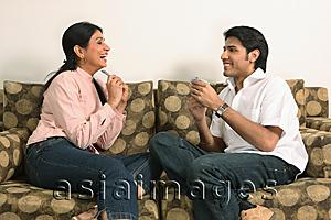 Asia Images Group - Husband and wife playing cards