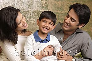 Asia Images Group - parents smile proudly at their son, son smiles at camera
