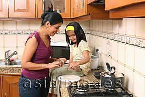 Asia Images Group - Mother and daughter in kitchen