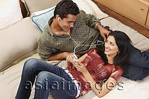 Asia Images Group - couple lounging on bed