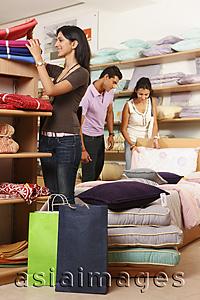 Asia Images Group - three people shopping in fabric store