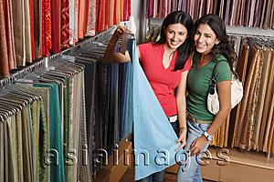 Asia Images Group - two girls shopping for fabric