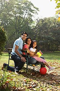 Asia Images Group - Family on park bench, red ball