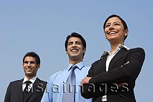 Asia Images Group - three colleagues standing, woman has arms folded