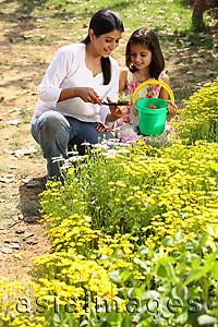 Asia Images Group - Mother and daughter with green pail