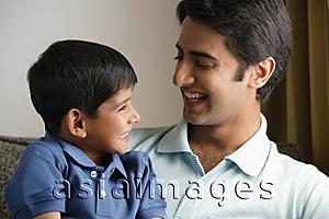 Asia Images Group - father and son smiling at each other
