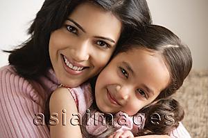Asia Images Group - close up of mother and daughter hugging and smiling at camera