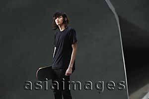 Asia Images Group - young man holding skateboard