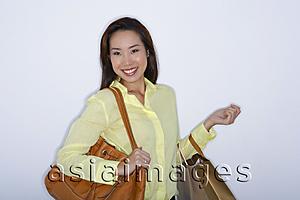 Asia Images Group - woman with purse and shopping bags