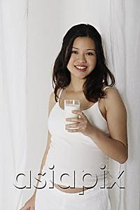 AsiaPix - Pregnant woman holding glass of milk