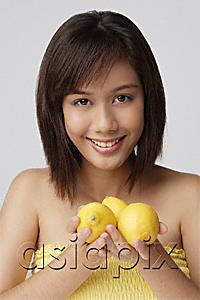 AsiaPix - Young woman holding lemons