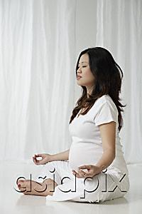 AsiaPix - Pregnant woman meditating