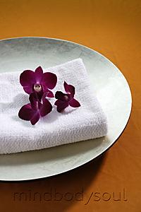 Mind Body Soul - purple orchids on top of spa towel