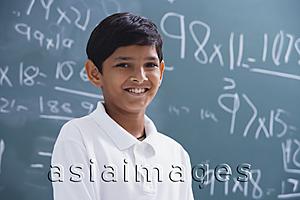 Asia Images Group - boy in front of chalkboard smiling