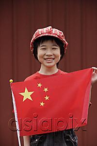 AsiaPix - Portrait of little girl standing behind Chinese flag