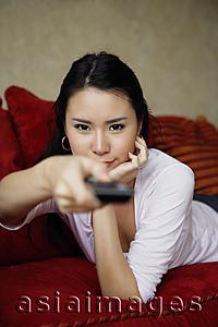 Asia Images Group - woman holding channel-changer