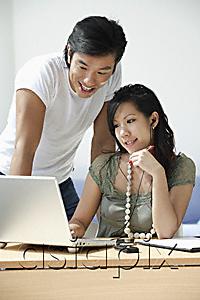 AsiaPix - Young couple working at computer